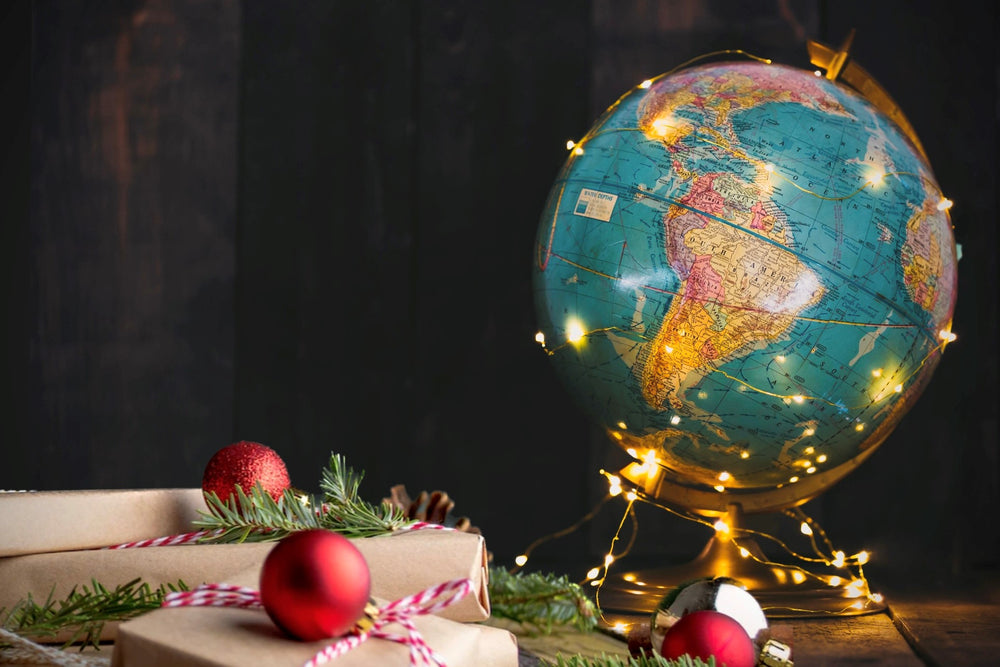 Globe covered in holiday lights to represent Christmas Around The World