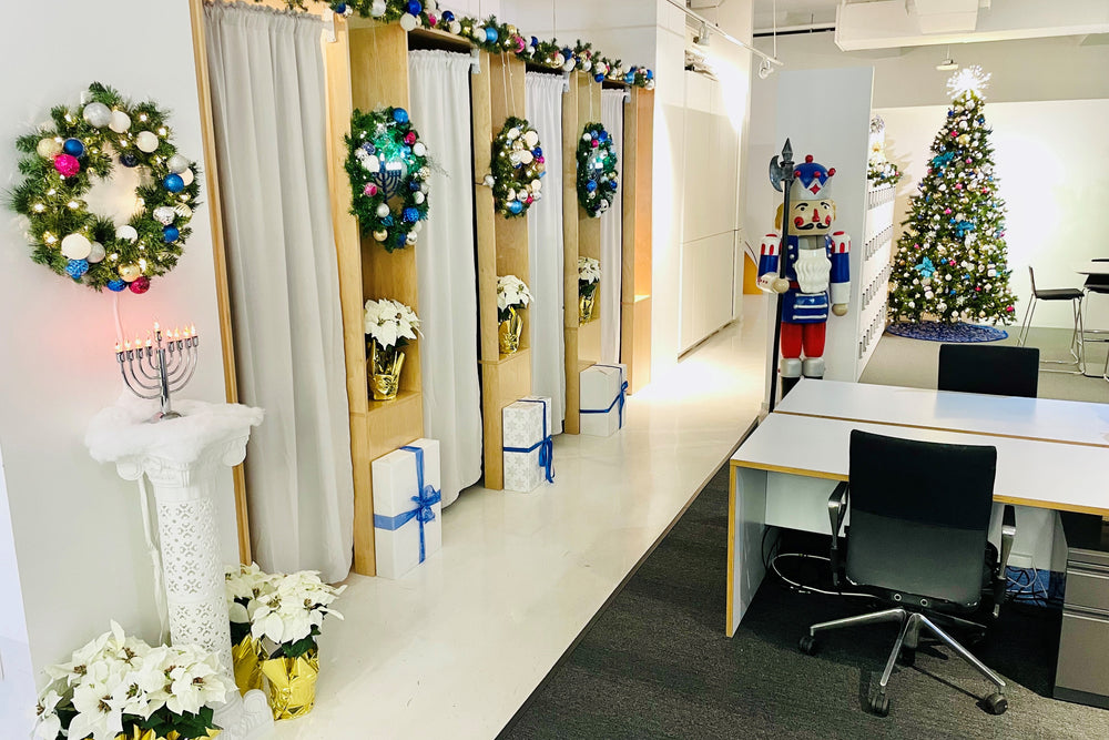 A nutcracker, Christmas Tree and other holiday decorations on display in a fun office environment.