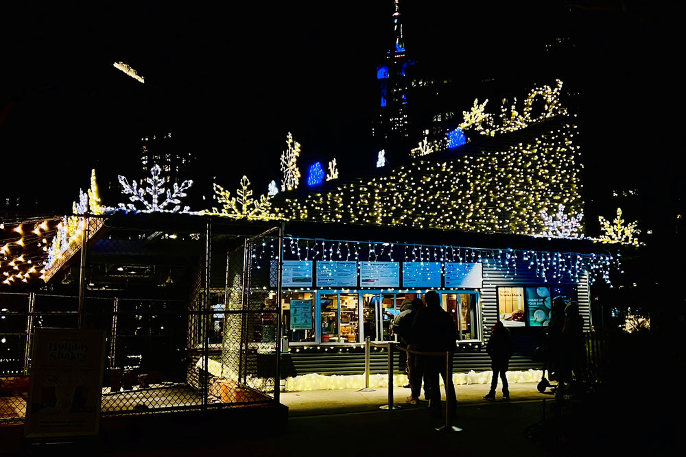 Shake Shack Madison Square Park Location covered in Christmas Lights and Oversized Snowflakes for the 2022 Holiday Season in NYC.