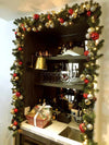 A Christmas garland around a cozy desk nook