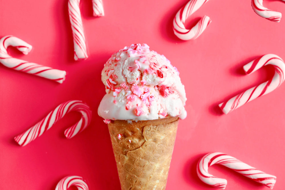 Imagine of Candy Cane Ice Cream in a Cone with mini-candy canes around it, showcasing a delicious recipe from the Rent-A-Christmas Elf Squad Kitchen