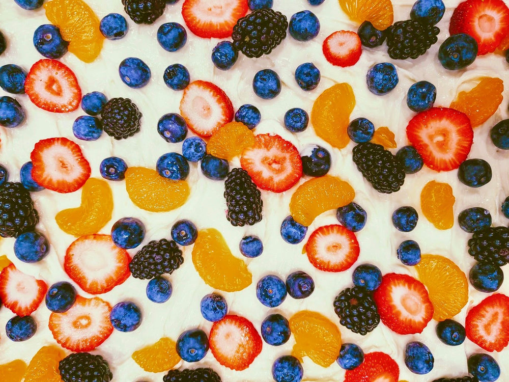 Assorted Fruit on Cream Cheese Frosting and a Sugar Cookie Crust in this Fruit Pizza Recipe from the Rent-A-Christmas Elf Squad Kitchen